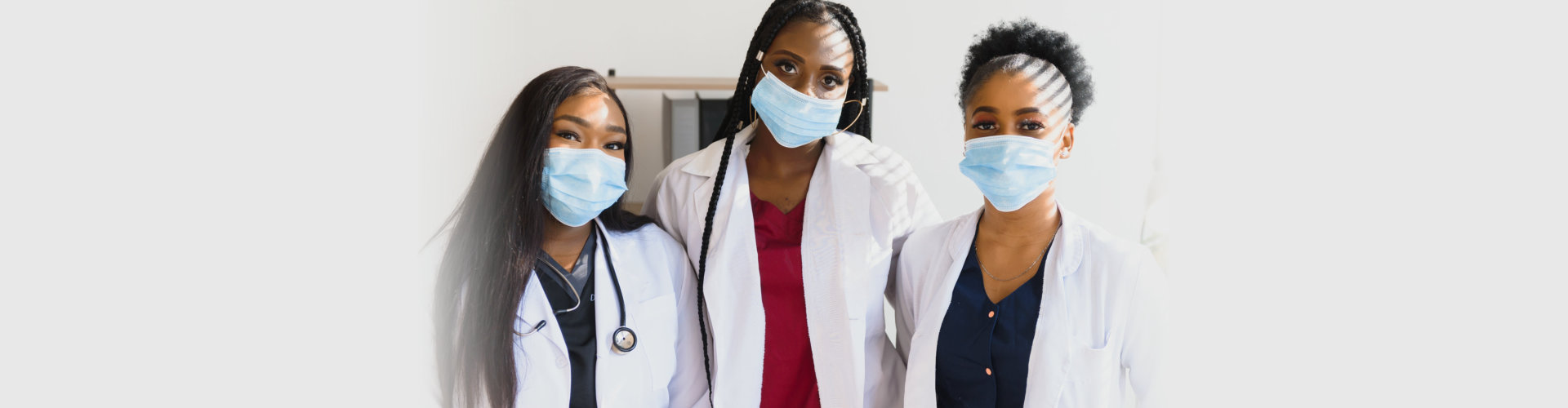Group of African American female doctors in protective masks on their faces