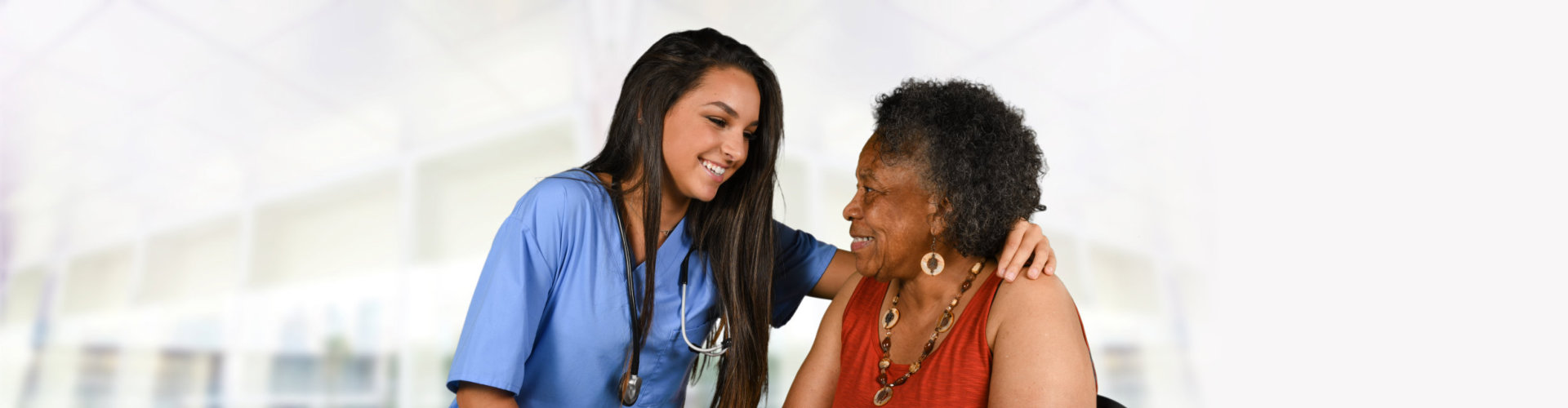 Health care worker helping an elderly woman